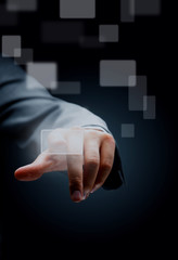 hand pushing a button on a touch screen interface.