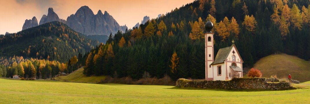 St. Johann (San Giovanni in Italian) chapel in Val di Funes with the Dolomites Odle group on background. Northern Italy.