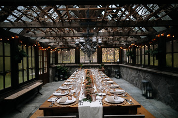 Set tables for fancy dinner in a green house