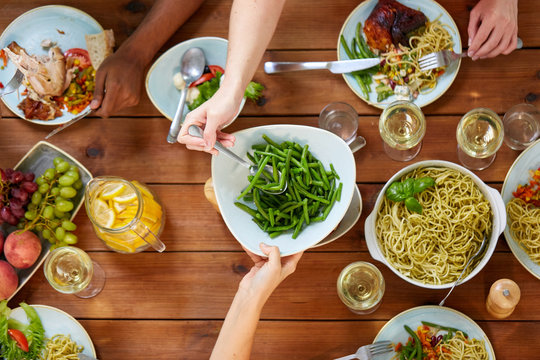 People At Table With Food Eating Green Beans