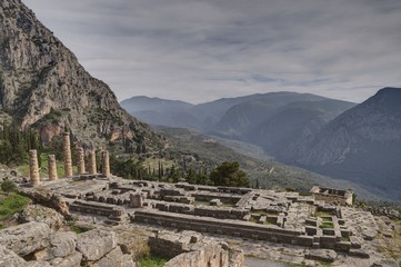 Apollo Temple in Delphi and ancient theatre, an archaeological site in Greece, at the Mount Parnassus. Delphi is famous by the oracle at the sanctuary dedicated to Apollo. UNESCO World heritage