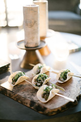 speared tacos on a wooden plate