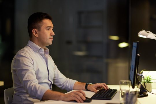 businessman with computer working at night office