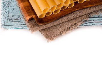 Italian pasta cannelloni. Raw tube for stuffing stuffing surrounded by ingredients for cooking,...