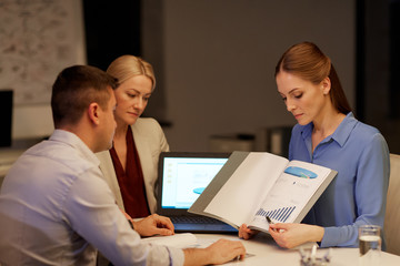 business team with papers working late at office