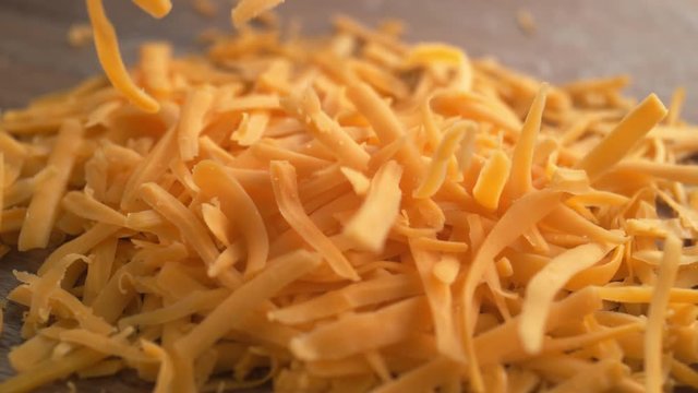 Grating cheddar cheese. Shot with high speed camera, phantom flex 4K. Slow Motion.