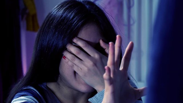 Woman at night scared of man domestic violence