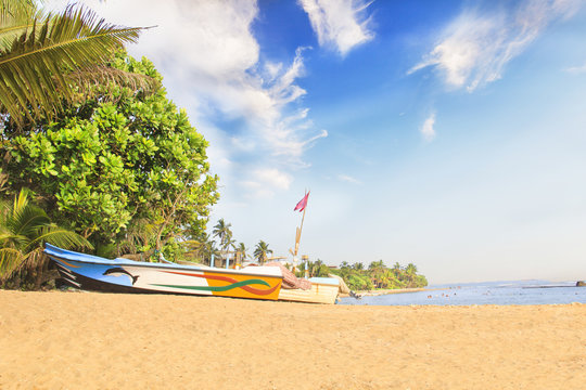 Bright boats on the tropical beach of Bentota, Sri Lanka on a sunny day