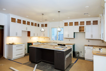 Installing new induction hob in modern kitchen kitchen Installation of kitchen cabinet.