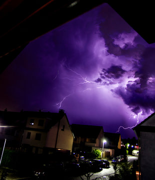 Dark weather with purple lightning strikes in the sky