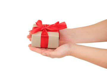 presentation of gift, hands giving a gift wrapped with red ribbon on white background top view
