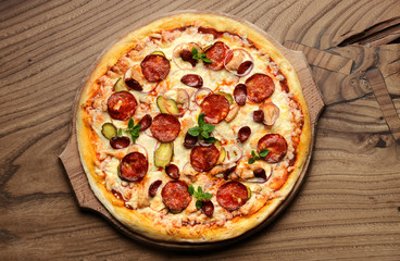 Hot big pepperoni pizza tasty pizza composition with melting cheese bacon tomatoes ham paprika