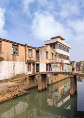 Fototapeta na wymiar Row of traditional style houses reflected in a canal, Wenzhou, Zhejiang Province, China