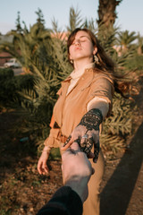 Couple holding hands with henna tattoo