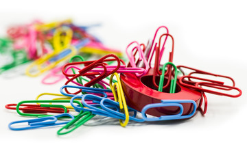 Magnet covered by paper clips isolated on a white background