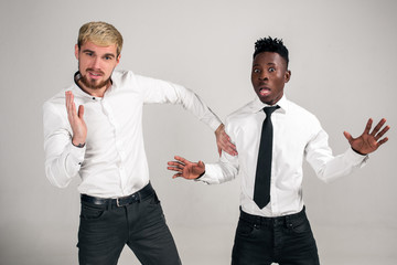 Two stylish men posing and having fun on white background.