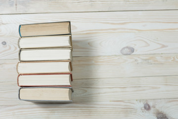 Pile of old books stacked on top of each other.