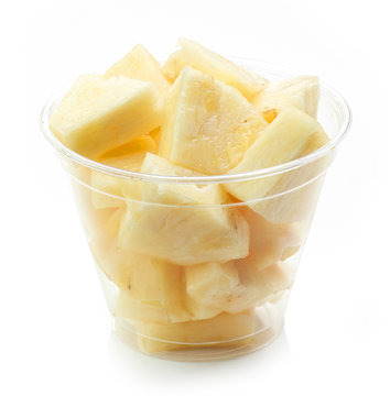 fresh pineapple pieces salad in plastic cup