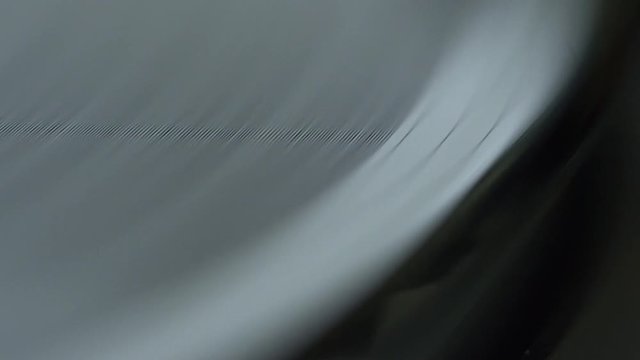 Macro shot of vinyl record playing and stylus needle dropping onto record.