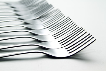 Fork background / A fork, in cutlery or kitchenware, is a tool consisting of a handle with several...