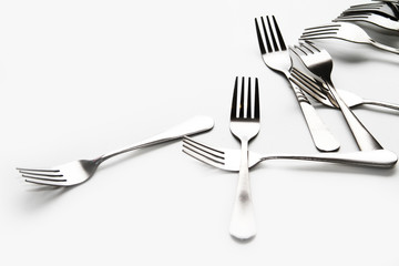 Fork background / A fork, in cutlery or kitchenware, is a tool consisting of a handle with several narrow tines on one end.