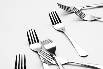 Fork background / A fork, in cutlery or kitchenware, is a tool consisting of a handle with several narrow tines on one end.