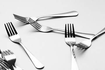 Fork background / A fork, in cutlery or kitchenware, is a tool consisting of a handle with several narrow tines on one end.