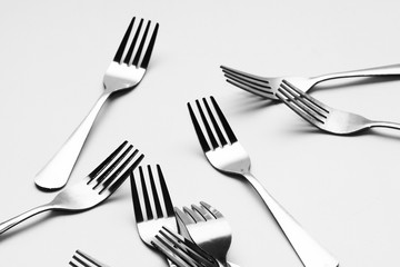 Fork background / A fork, in cutlery or kitchenware, is a tool consisting of a handle with several narrow tines on one end.