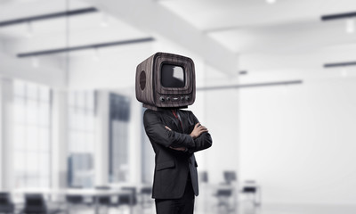 Businessman with old TV instead of head.