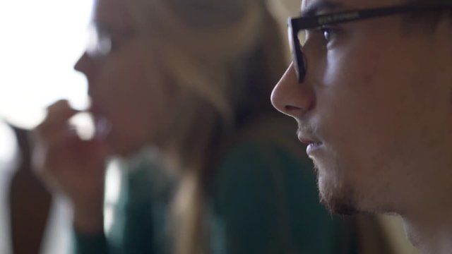 Focus shift from son to mother, both in profile.