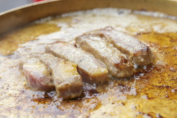 close up of beef sirloin grilling on charcoal stove