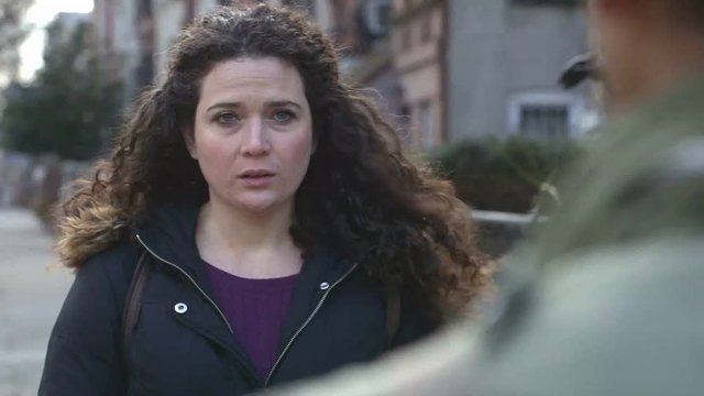 Closeup of sad woman on street.