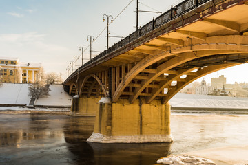 Kirov's bridge of arch construction Belarus, view from below to the bank of the river in winter time