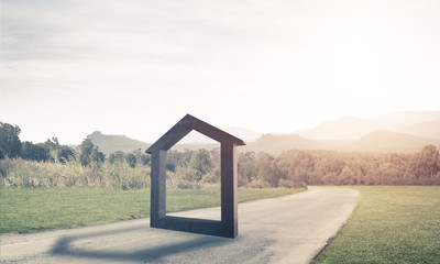 Fototapeta premium Conceptual background image of concrete home sign on asphalt roa