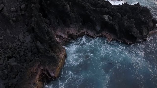 Aerial of waves pounding a rocky coast