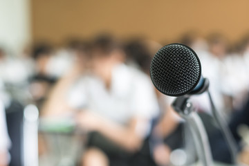 Microphone voice speaker with audiences or students in seminar classroom, lecture hall or...