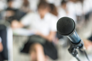 Microphone voice speaker with audiences or students in seminar classroom, lecture hall or conference meeting in educational business event for host, teacher, or coaching mentor