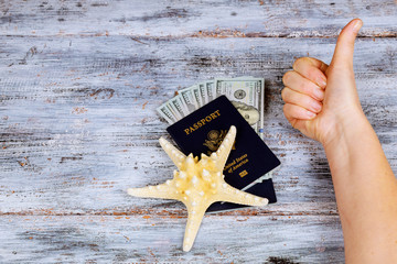 preparation for vacation, a passport with money to rest on the table sea star