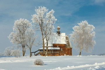 Russian winter landscape in Suzdal. Wooden Orthodox church of St. Nicholas in the Suzdal Kremlin on...