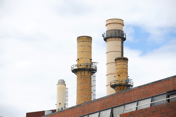 close up on old industrial smokestacks 