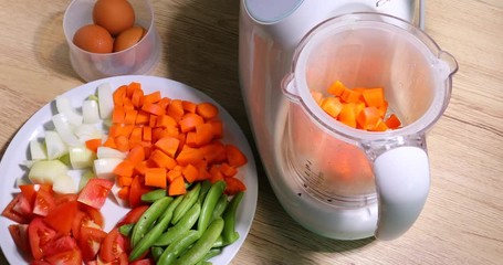 woman pouring sliced vegetable in kitchenware multi-functional electric household appliance food steamer