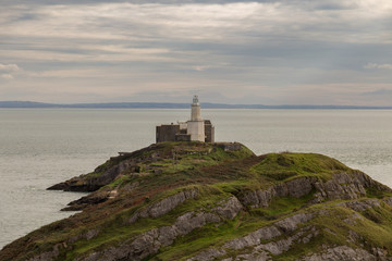Fototapeta na wymiar A cloudy day at Mumbles Head Lighthouse in Swansea, Wales, UK