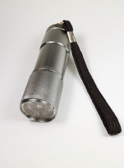 metal LED flashlight on a white 