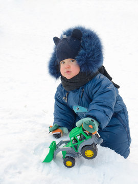 A small child plays on the Playground.