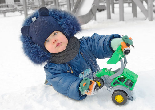 A small child plays on the Playground.