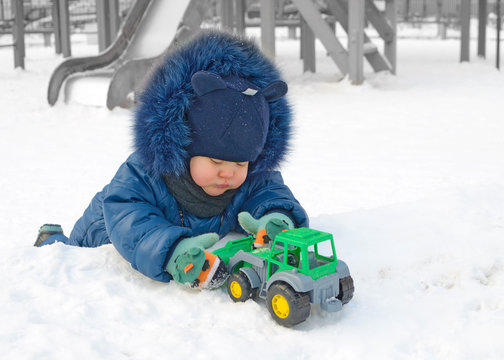 A small child plays on the Playground.