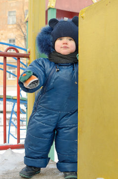A small child plays on the Playground.