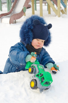 A small child plays on the Playground.
