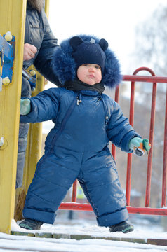 A small child plays on the Playground.