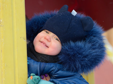 A small child plays on the Playground.